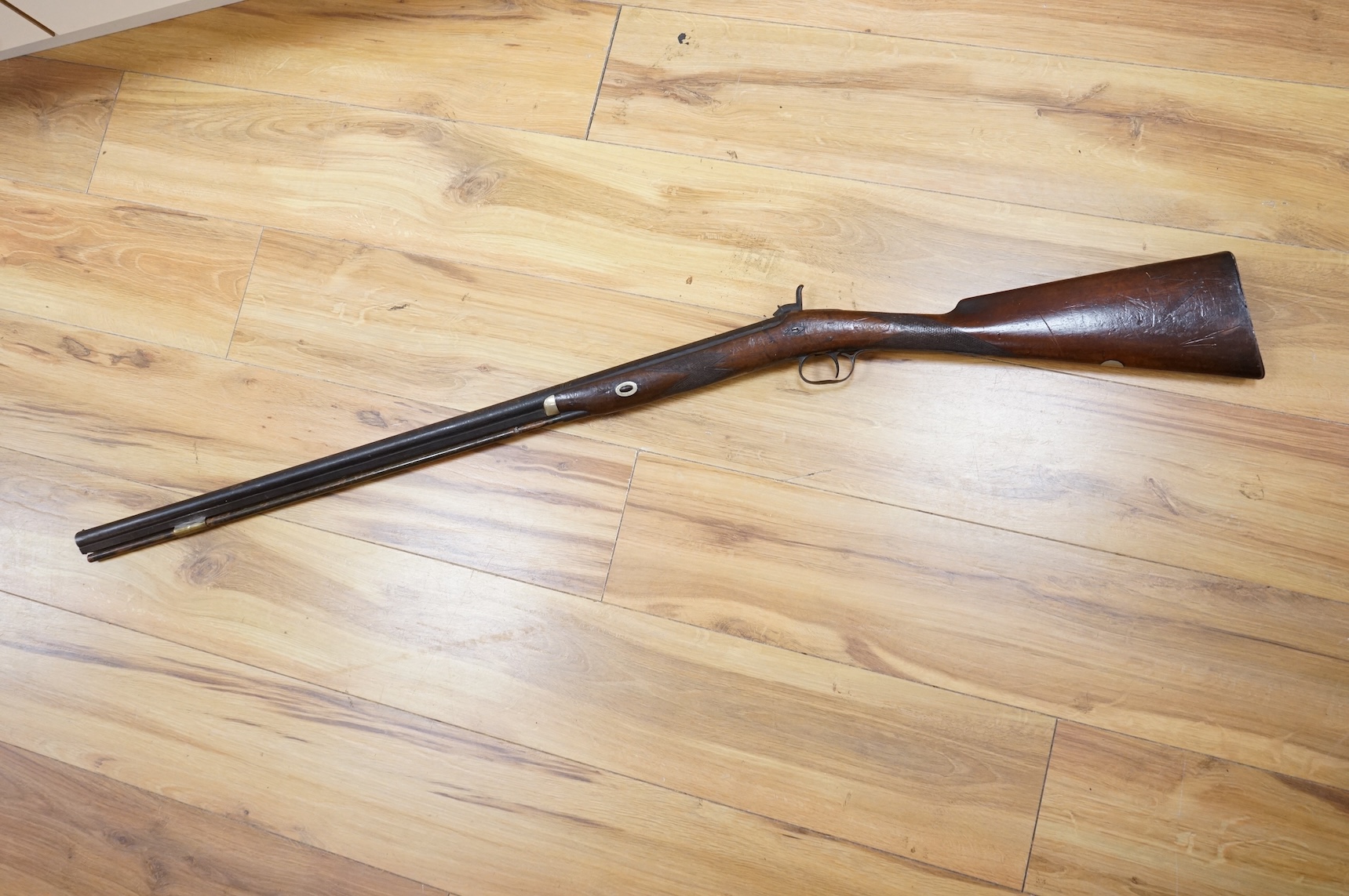 An English 16 bore back action, single barrel, percussion sporting gun, with half octagonal barrel half-stocked, barrel 82cm, iron mounted, chequered grip and fore end